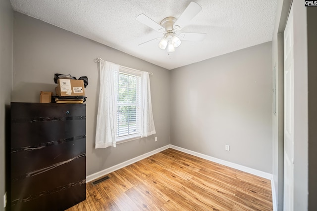 144 Stephanie Dr, Lexington, SC 29073 - spare room with a textured ceiling, light wood-style flooring, baseboards, and ceiling fan