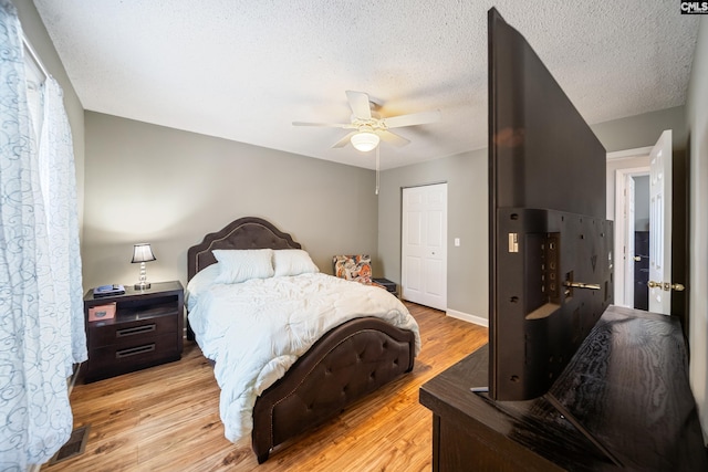 144 Stephanie Dr, Lexington, SC 29073 - bedroom with light wood-type flooring, a textured ceiling, a closet, and a ceiling fan