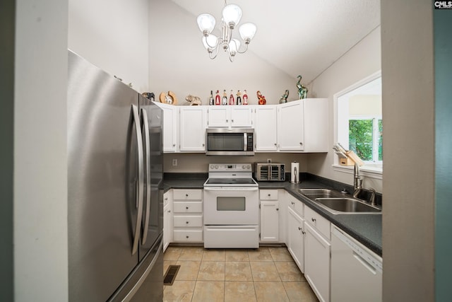144 Stephanie Dr, Lexington, SC 29073 - kitchen featuring stainless steel appliances, a sink, vaulted ceiling, dark countertops, and white cabinets