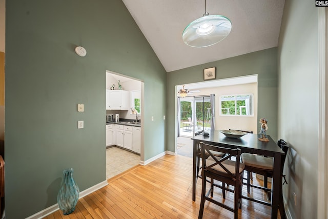 144 Stephanie Dr, Lexington, SC 29073 - dining room with light wood-type flooring, high vaulted ceiling, ceiling fan, and baseboards