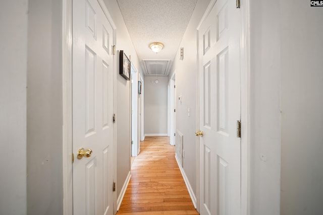 144 Stephanie Dr, Lexington, SC 29073 - hall featuring attic access, light wood-type flooring, baseboards, and a textured ceiling