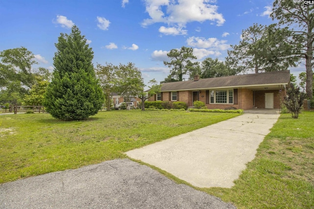 1629 B Ave, West Columbia, SC 29169 - view of front of home featuring driveway, brick siding, an attached carport, and a chimney