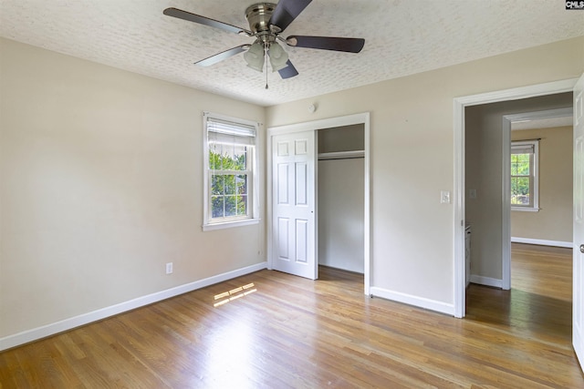 1629 B Ave, West Columbia, SC 29169 - unfurnished bedroom with baseboards, wood finished floors, a closet, and a textured ceiling