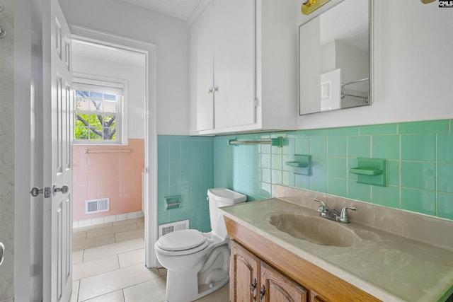 1629 B Ave, West Columbia, SC 29169 - bathroom with tile patterned flooring, toilet, a wainscoted wall, vanity, and tile walls