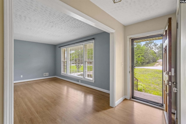 1629 B Ave, West Columbia, SC 29169 - entrance foyer with wood finished floors, baseboards, plenty of natural light, and a textured ceiling