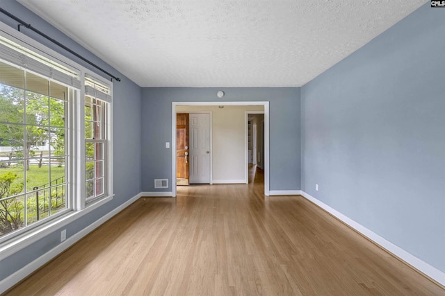 1629 B Ave, West Columbia, SC 29169 - unfurnished room with a textured ceiling, wood finished floors, and baseboards