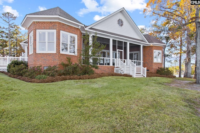 208 Ballentine Ln, Chapin, SC 29036 - neoclassical home featuring brick siding, a sunroom, a shingled roof, and a front yard