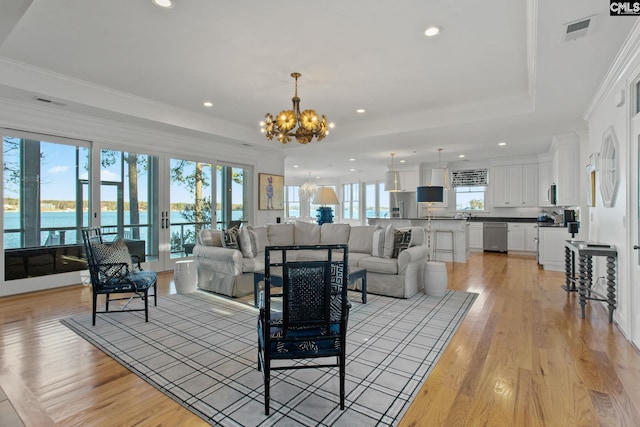 208 Ballentine Ln, Chapin, SC 29036 - living area featuring a chandelier, a raised ceiling, recessed lighting, light wood-style floors, and crown molding