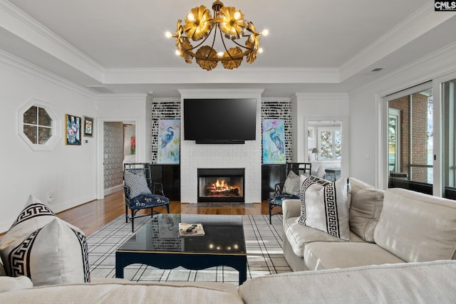 208 Ballentine Ln, Chapin, SC 29036 - living area with wood finished floors, plenty of natural light, a brick fireplace, a tray ceiling, and crown molding