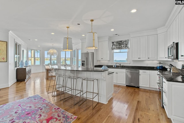 208 Ballentine Ln, Chapin, SC 29036 - kitchen featuring stainless steel appliances, a sink, recessed lighting, a kitchen breakfast bar, and light wood finished floors