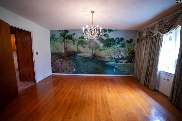 109 Mcrae St, Columbia, SC 29203 - unfurnished dining area featuring wood finished floors, a chandelier, and baseboards