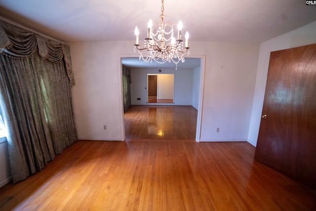 109 Mcrae St, Columbia, SC 29203 - unfurnished room with a chandelier, light wood-style flooring, and baseboards