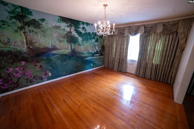 109 Mcrae St, Columbia, SC 29203 - empty room featuring wood finished floors, a chandelier, and baseboards