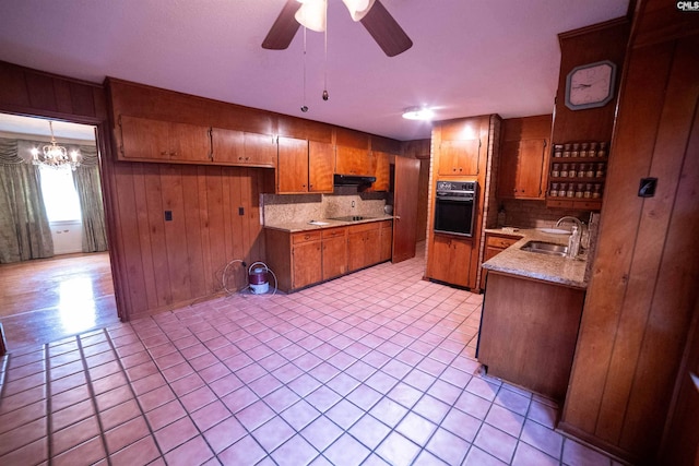 109 Mcrae St, Columbia, SC 29203 - kitchen with black appliances, brown cabinetry, decorative backsplash, under cabinet range hood, and a ceiling fan