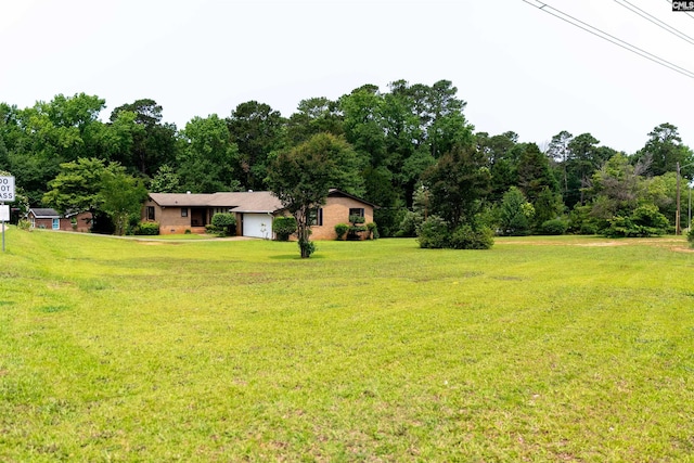 109 Mcrae St, Columbia, SC 29203 - view of grassy yard featuring an attached garage