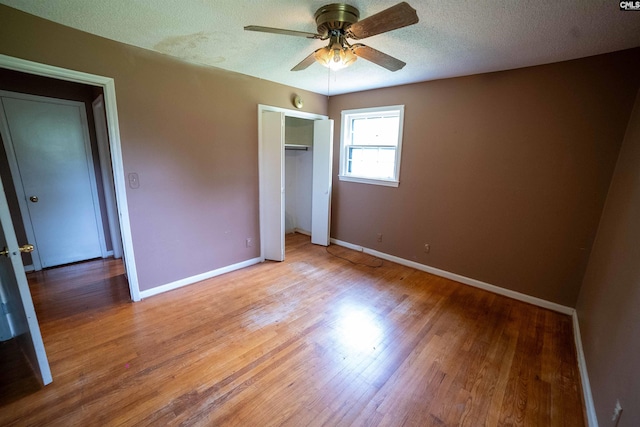 109 Mcrae St, Columbia, SC 29203 - unfurnished bedroom with light wood-style flooring, baseboards, a closet, a textured ceiling, and ceiling fan