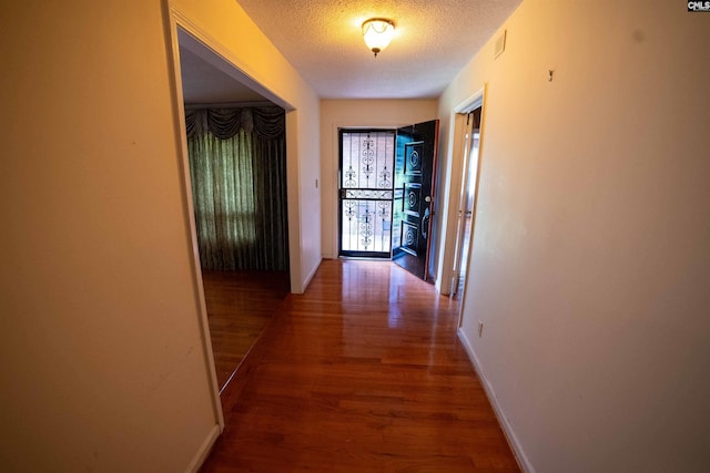 109 Mcrae St, Columbia, SC 29203 - corridor with wood finished floors, a textured ceiling, and baseboards