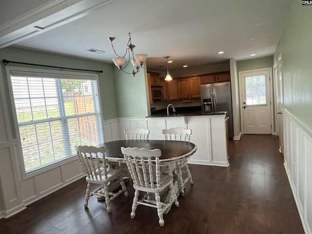 925 Corison Loop, Columbia, SC 29229 - dining room featuring a decorative wall, a chandelier, dark wood-style flooring, wainscoting, and recessed lighting