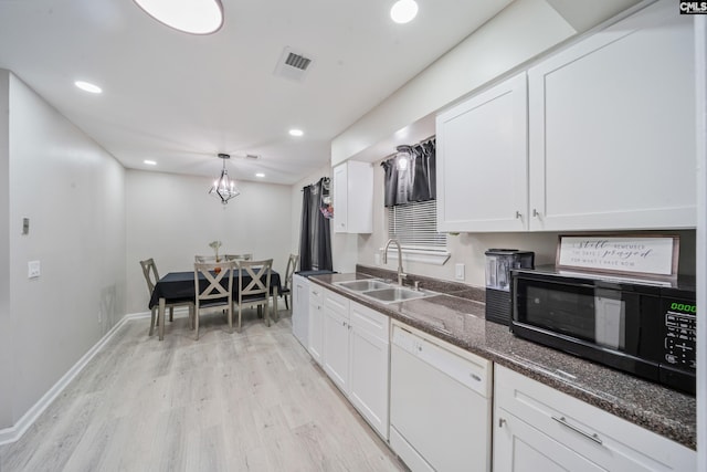 1 Rockingham Ct, Columbia, SC 29223 - kitchen with dishwasher, a sink, black microwave, light wood-style floors, and white cabinetry