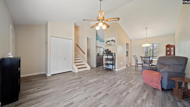 530 Pin Oak Dr, Lexington, SC 29073 - living area with wood finished floors, ceiling fan, high vaulted ceiling, baseboards, and stairway