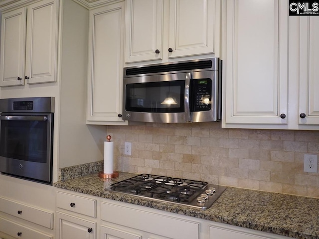 522 Meadow Grass Ln, Lexington, SC 29072 - kitchen with stainless steel appliances, decorative backsplash, dark stone counters, and white cabinetry