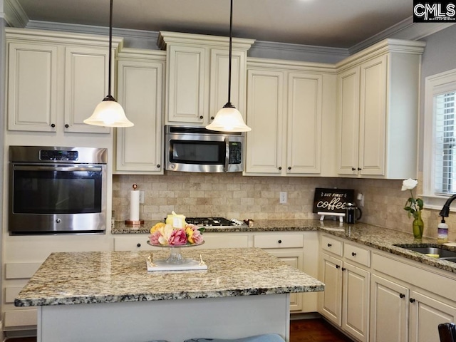 522 Meadow Grass Ln, Lexington, SC 29072 - kitchen featuring appliances with stainless steel finishes, a sink, cream cabinetry, ornamental molding, and light stone counters