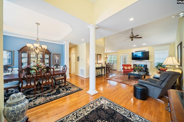 55 Hickory Woods Ct, Columbia, SC 29223 - living area featuring decorative columns, wood finished floors, ceiling fan, a fireplace, and a chandelier