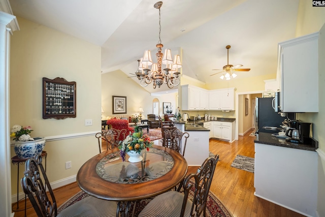 55 Hickory Woods Ct, Columbia, SC 29223 - dining area featuring a chandelier, ceiling fan, lofted ceiling, and light wood-style flooring