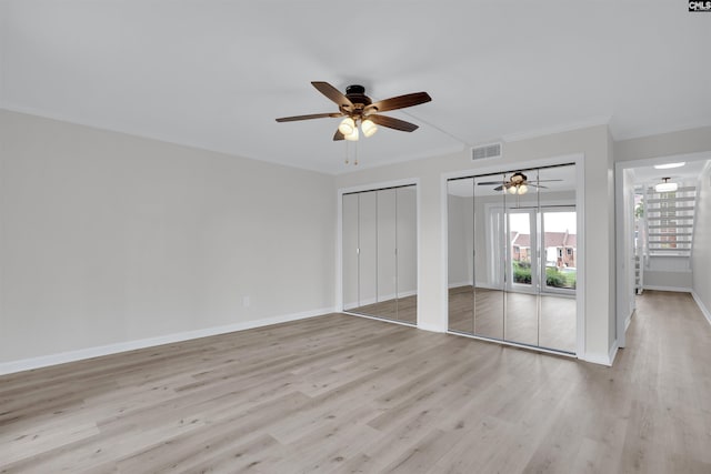 10 Low Hill Ln, Lexington, SC 29072 - unfurnished bedroom featuring two closets, light wood-style floors, crown molding, baseboards, and ceiling fan