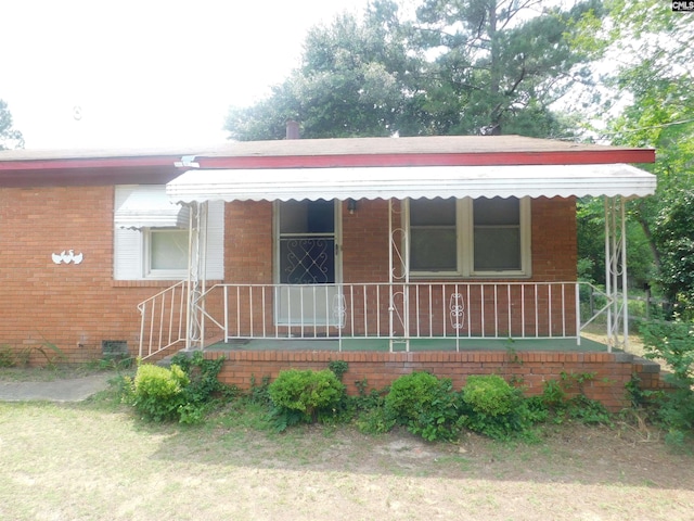 572 National St, Sumter, SC 29150 - view of front of house featuring covered porch and brick siding
