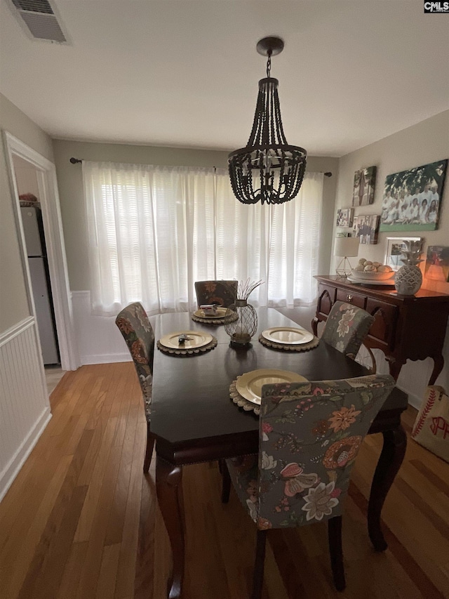 150 Azalea Ave, Bamberg, SC 29003 - dining space with wood finished floors, a chandelier, and a wainscoted wall