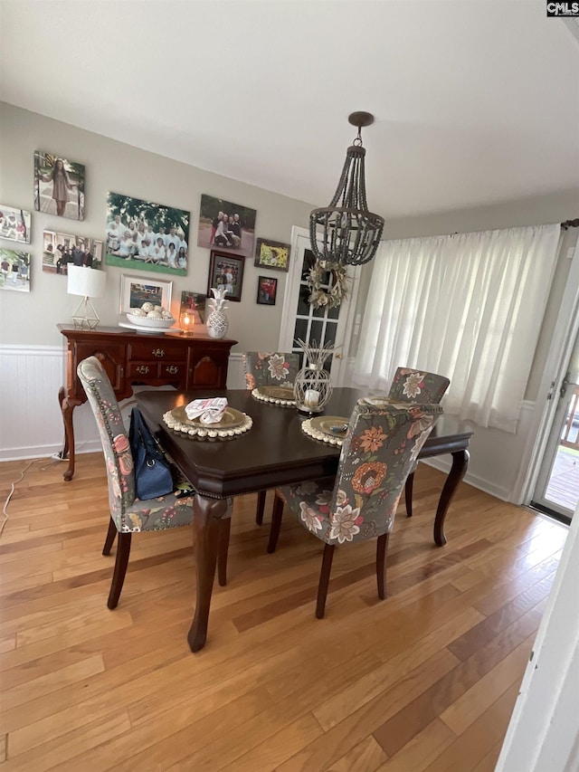 150 Azalea Ave, Bamberg, SC 29003 - dining room with light wood-style flooring, a wainscoted wall, and a chandelier