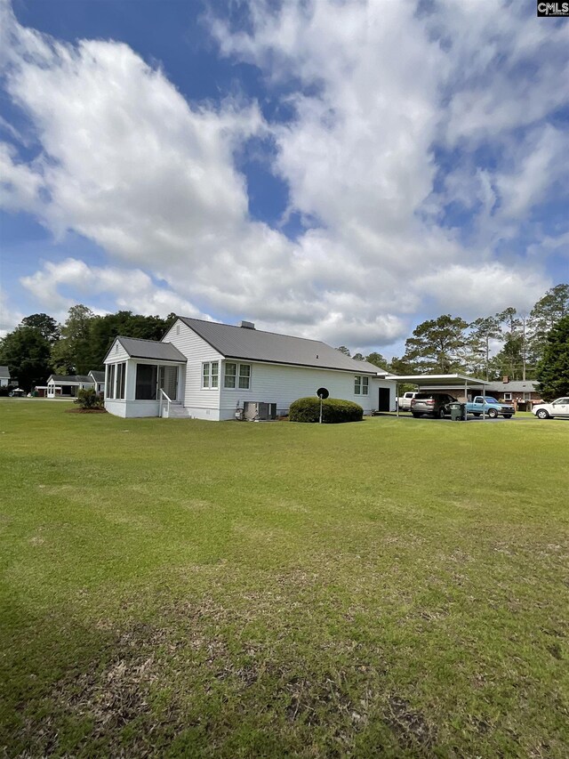150 Azalea Ave, Bamberg, SC 29003 - view of side of property with a sunroom, a lawn, and cooling unit