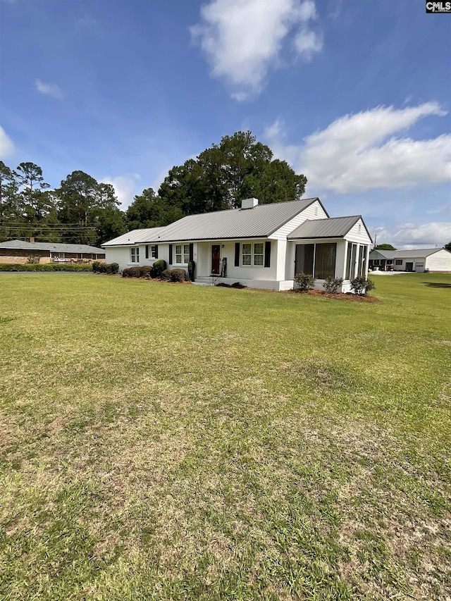 150 Azalea Ave, Bamberg, SC 29003 - ranch-style home with a front yard, metal roof, and a sunroom