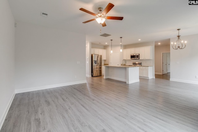 412 Blue Robin Ln, Columbia, SC 29210 - unfurnished living room featuring light wood-type flooring, a ceiling fan, recessed lighting, and a chandelier