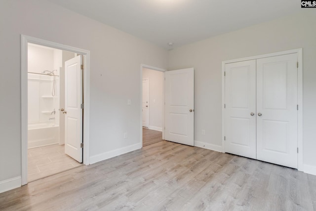 412 Blue Robin Ln, Columbia, SC 29210 - unfurnished bedroom with light wood-style flooring, connected bathroom, baseboards, and a closet