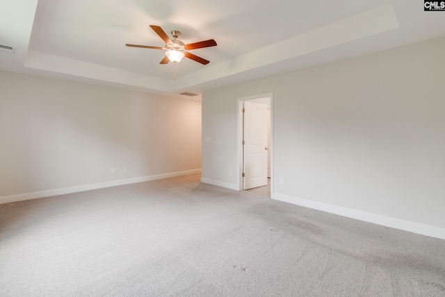 412 Blue Robin Ln, Columbia, SC 29210 - unfurnished room featuring a tray ceiling, a ceiling fan, baseboards, and light carpet