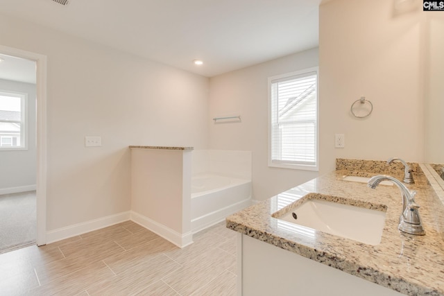 412 Blue Robin Ln, Columbia, SC 29210 - bathroom featuring double vanity, a garden tub, plenty of natural light, baseboards, and recessed lighting