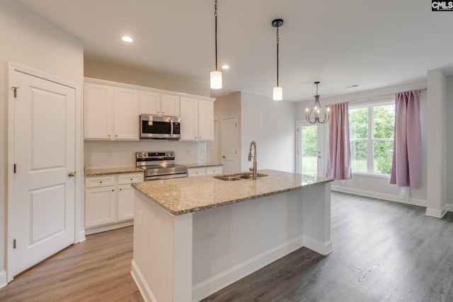 412 Blue Robin Ln, Columbia, SC 29210 - kitchen with appliances with stainless steel finishes, a sink, light wood-type flooring, white cabinets, and recessed lighting