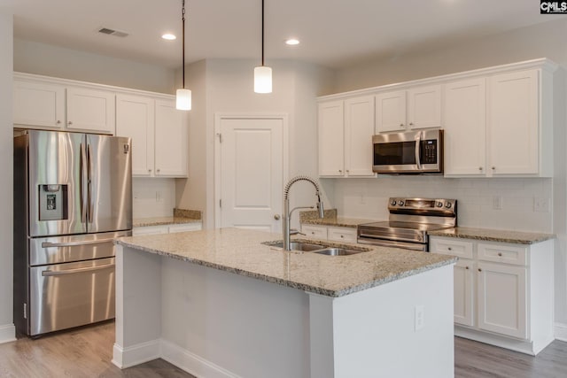 412 Blue Robin Ln, Columbia, SC 29210 - kitchen with stainless steel appliances, a sink, light wood-type flooring, recessed lighting, and white cabinetry