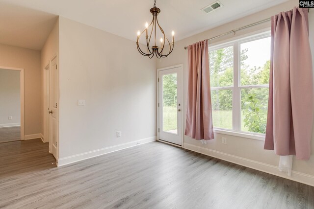 412 Blue Robin Ln, Columbia, SC 29210 - empty room with wood finished floors, a chandelier, healthy amount of natural light, and baseboards