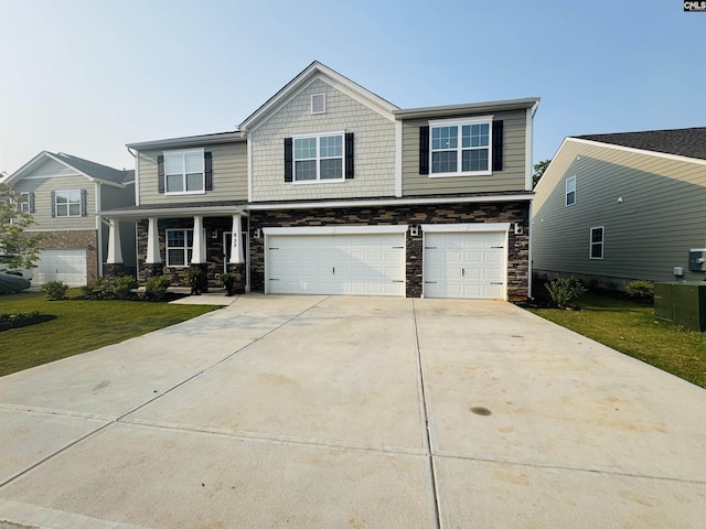822 Marigold Ln, Lexington, SC 29072 - craftsman-style home with an attached garage, stone siding, concrete driveway, a front yard, and covered porch