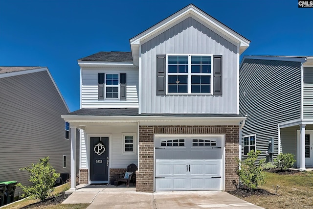 2426 Trakand Dr, Lexington, SC 29073 - view of front of property with an attached garage, brick siding, board and batten siding, and roof with shingles