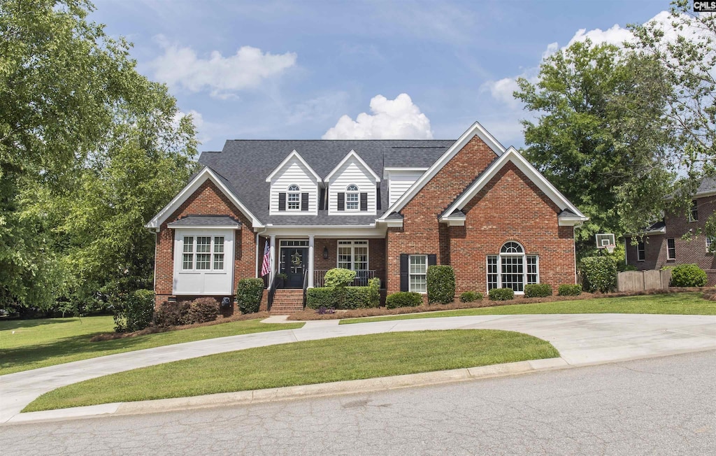 15 Clay Ct, Chapin, SC 29036 - traditional-style home featuring brick siding, a front lawn, curved driveway, and a porch