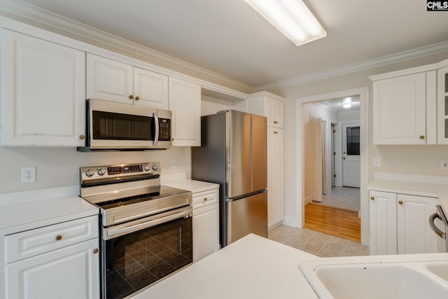 311 Hillridge Way, Columbia, SC 29229 - kitchen featuring stainless steel appliances, crown molding, white cabinetry, light countertops, and a sink