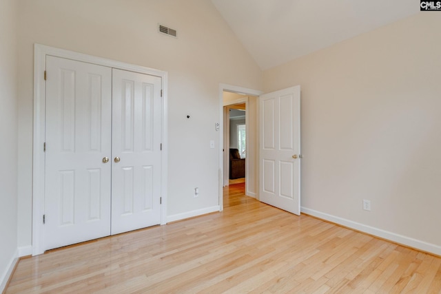 311 Hillridge Way, Columbia, SC 29229 - unfurnished bedroom with light wood finished floors, baseboards, a closet, and high vaulted ceiling