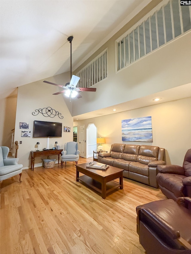 213 River Xing, Lexington, SC 29072 - living room featuring a high ceiling, light wood-type flooring, a ceiling fan, arched walkways, and baseboards