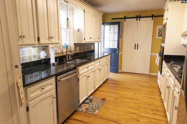 213 River Xing, Lexington, SC 29072 - kitchen with stainless steel appliances, a sink, tasteful backsplash, light wood-type flooring, and a barn door