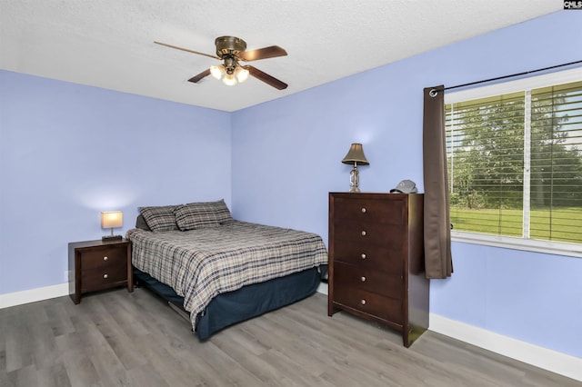 112 S Wrenwood Dr, Lexington, SC 29073 - bedroom with wood finished floors, baseboards, ceiling fan, and a textured ceiling