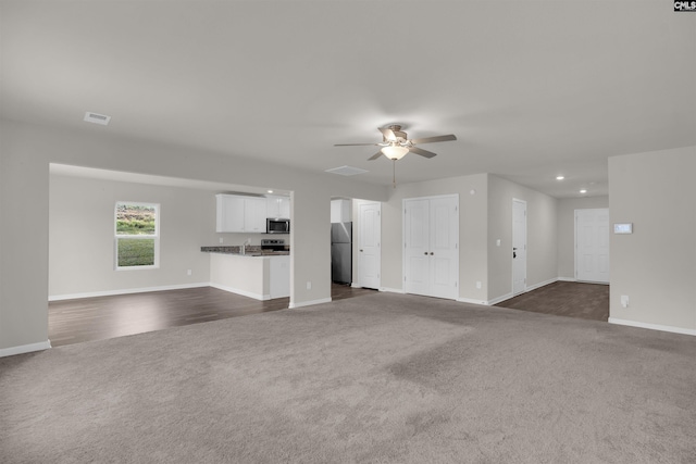 313 Greenwood Valley Ct, Elgin, SC 29045 - unfurnished living room featuring dark colored carpet, a ceiling fan, recessed lighting, baseboards, and arched walkways